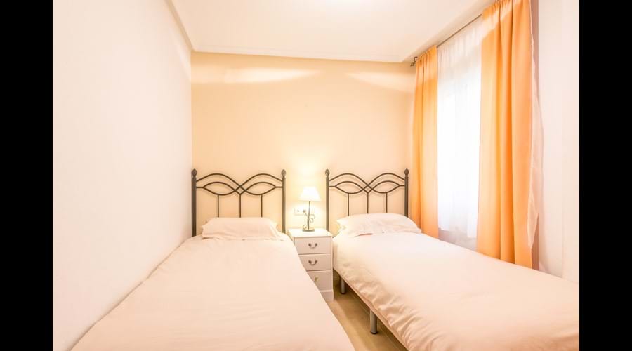 3rd bedroom (Twin), with large fitted wardrobe & storage chests, bedside locker and full-length mirror