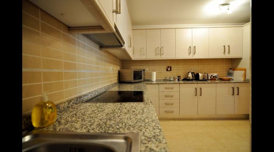 Large Kitchen inc ceramic hob, electric oven, fridge freezer and storage from end to end.