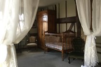 Cot seen from the four poster bed