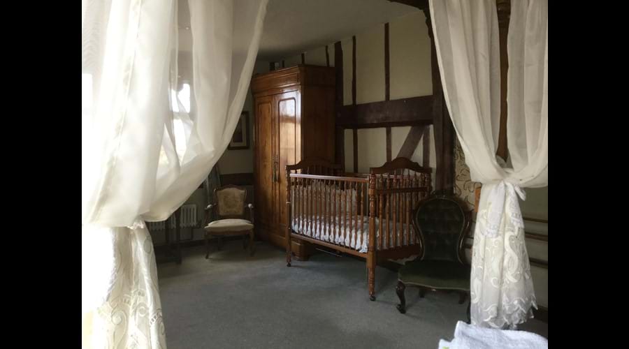 Cot seen from the four poster bed