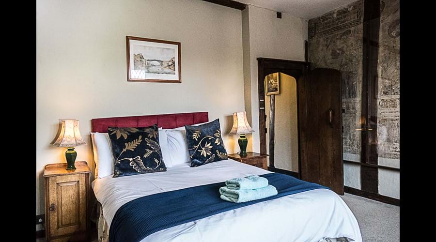 Double bedroom with stone fireplace and Jacobian wall paintings