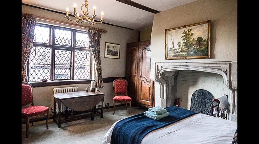 View of stone fireplace in double bedroom