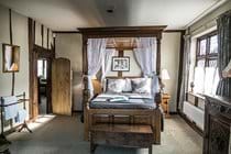 Another view of bedroom with four poster bed