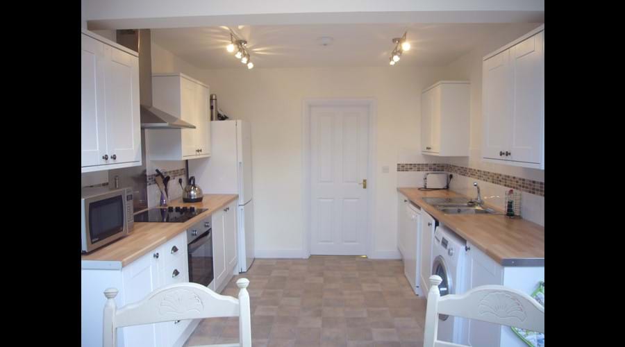 Dishwasher, microwave, fridge freezer and washing machine.