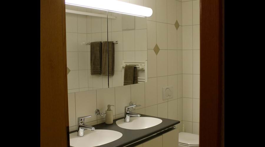 Modern bathroom with twin sinks.