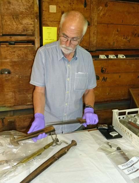 Examining African weaponry, Powell-Cotton Museum storeroom