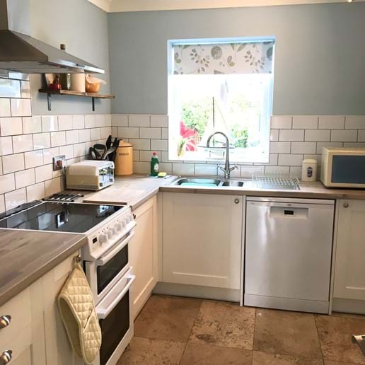kitchen with cooker and dishwasher, microwave, kettle and toaster and large fridge with 2 shelf  freezer