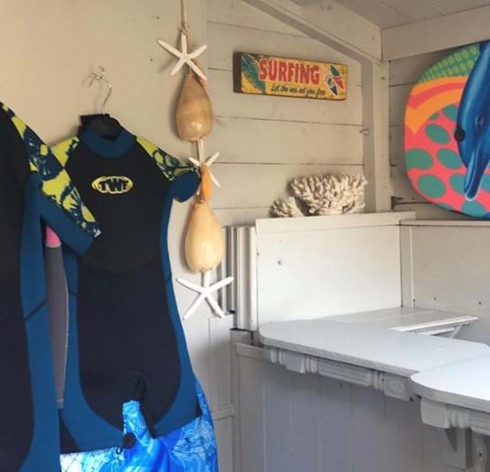 surf bar with boogy boards and wet suits for use
