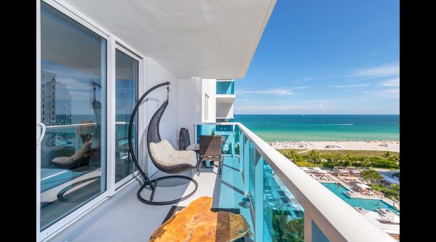 "Two comfortable swing chairs admire the fantastic South Beach View! "
