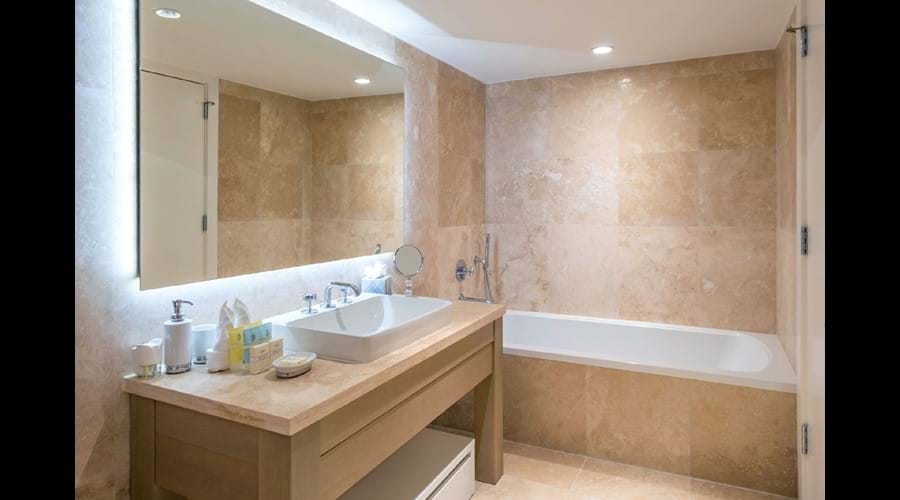 "Bathrooms finished in beautiful, floor-to-ceiling Travertine , Large bath "