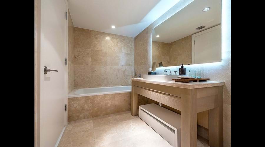 "Bathrooms finished in beautiful, floor-to-ceiling Travertine , Large bath "