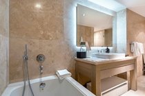 "Bathrooms finished in beautiful, floor-to-ceiling Travertine , Large bath "
