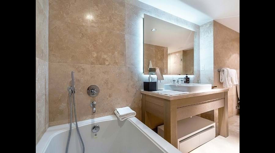 "Bathrooms finished in beautiful, floor-to-ceiling Travertine , Large bath "