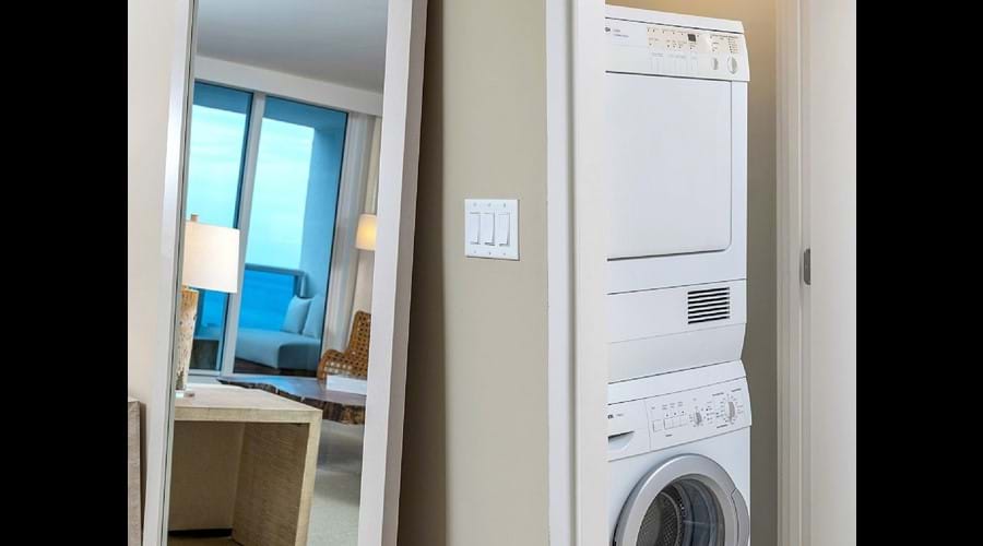 "Bosch washing machine and dryer tucked away iron ironing board etc"