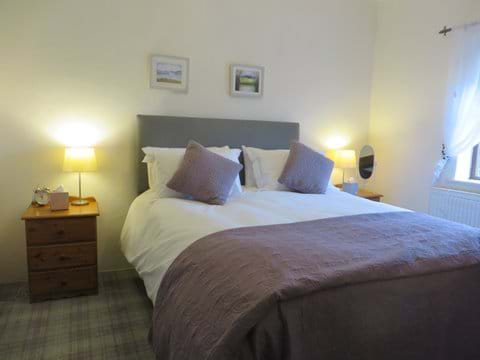 Double bedroom has king size bed, double wardrobe and en-suite with shower, wc and basin