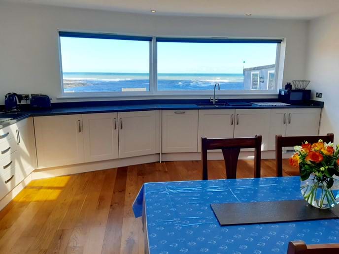 The kitchen is huge, light and airy, with a spectacular sea view