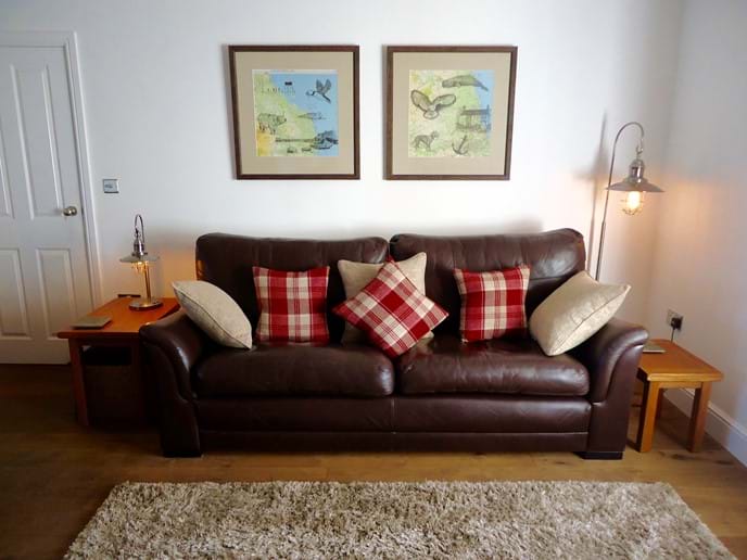 The leather sofa and armchairs are very comfortable, and the original artwork depicts local scenes and wildlife