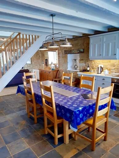 The kitchen is separated from the living area by the beautiful oak staircase. There is a slate tiled floor throughout the ground floor. 