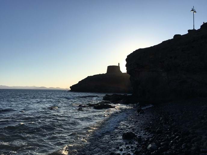 Castillo / Torre del Águila photo taken from sea shore next to coastal path from Las Coloradas to Marina Rubicon