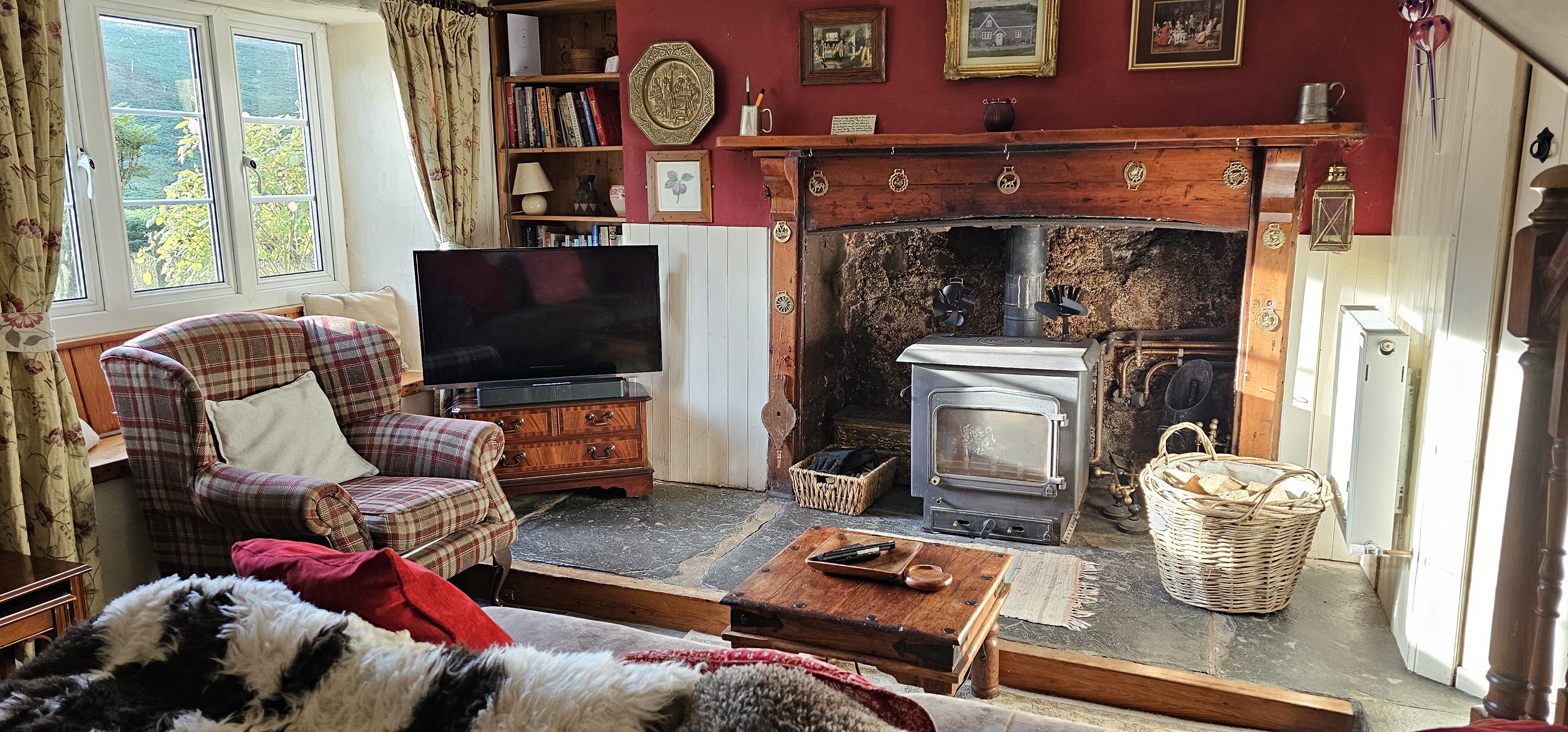 The sitting room with wood burner and TV