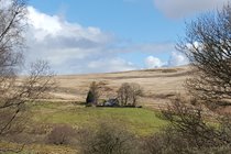 The back of the cottage from the hills