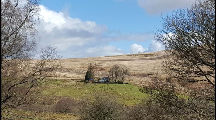The back of the cottage from the hills