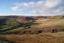 The view of the cottage from the hills opposite