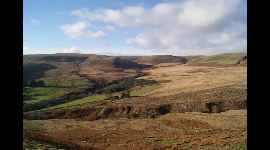 The view of the cottage from the hills opposite