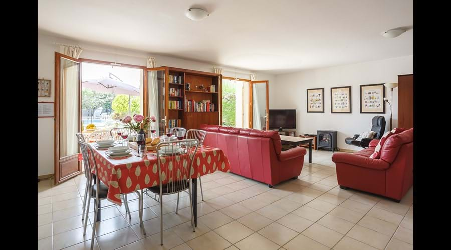 Dining and lounge area with patio doors