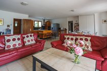 The vast open plan living area with the kitchen in the background