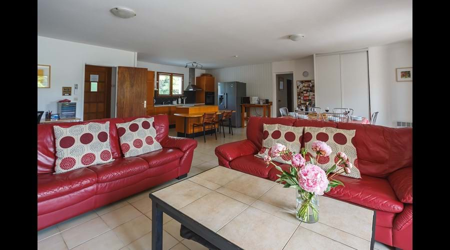 The vast open plan living area with the kitchen in the background