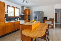 Kitchen with American fridge freezer and breakfast bar