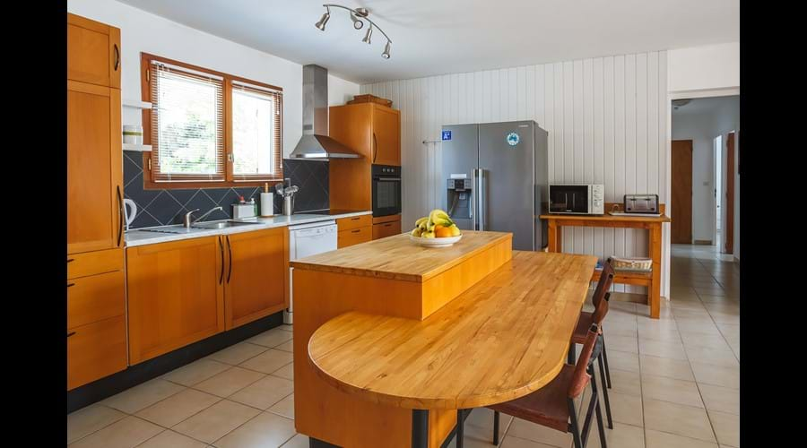 Kitchen with American fridge freezer and breakfast bar