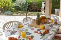 Outside dining under the shade of the terrace