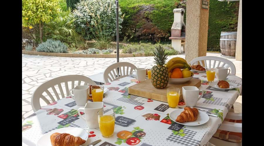 Outside dining under the shade of the terrace