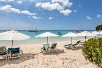 Beach with Coral Cove sunbeds and umbrellas