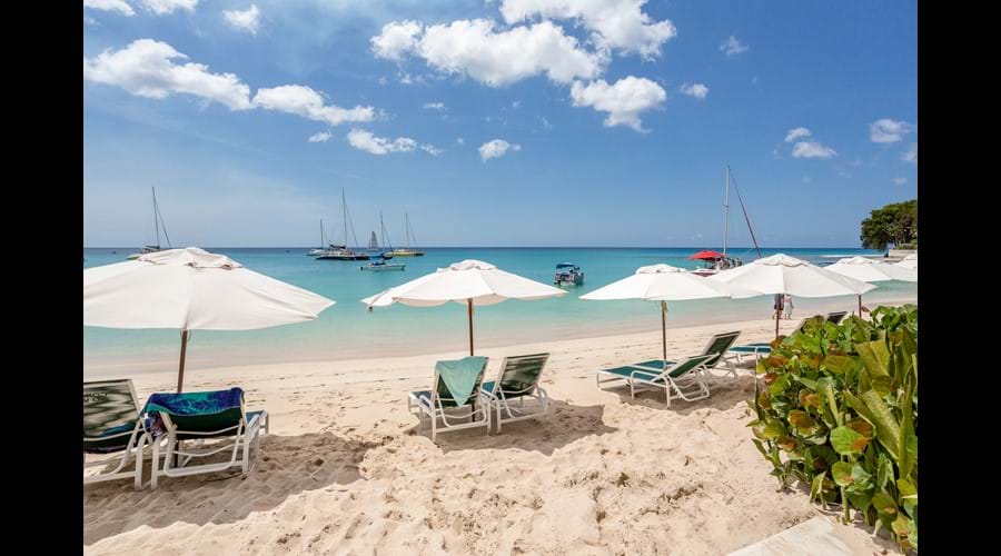 Beach with Coral Cove sunbeds and umbrellas