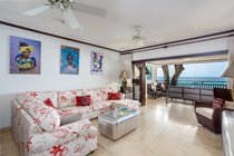 Internal loung area with L shaped sofa - Lovely wall art and great views on to our terrace