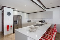 open new kitchen with American fridge and coffee maker in view with eating area