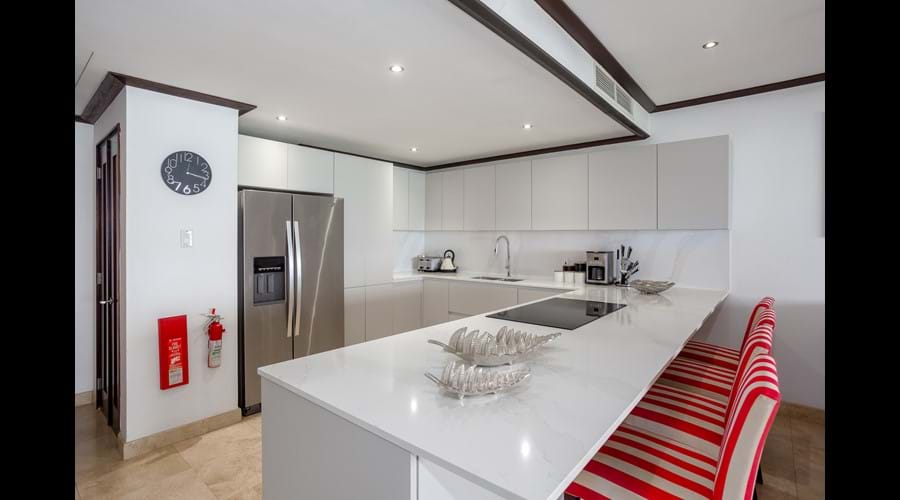open new kitchen with American fridge and coffee maker in view with eating area