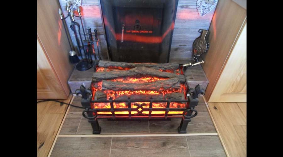 Vintage electric fire, kept in the cupboard next to the logburner for guests who prefer to use it