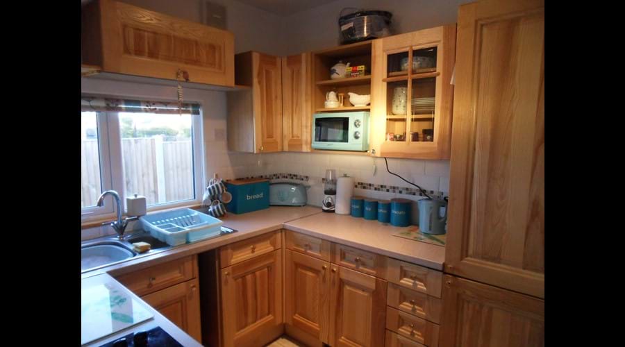 Lovely oak kitchen with built in fridge-freezer and dishwasher. Tea/coffee/biscuits/milk for your first drink on arrival