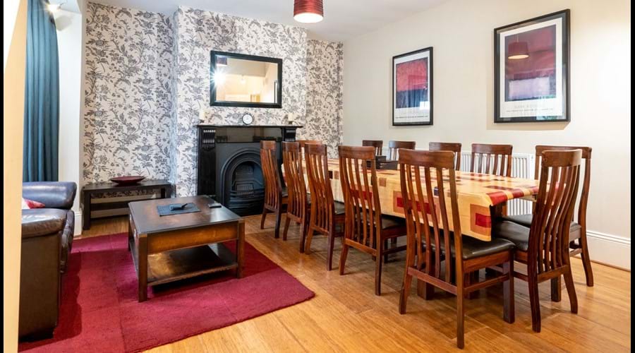 Dining Room with large table and 12 dining chairs, 2 sofas and coffee table.