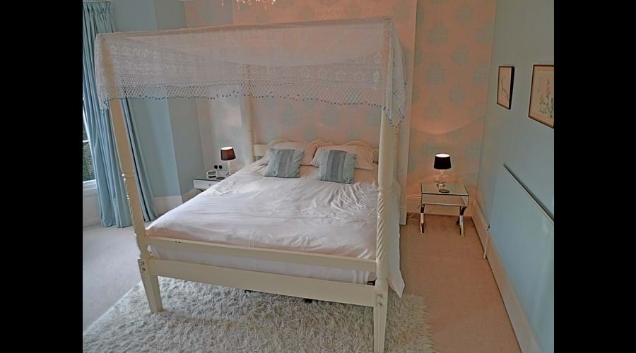 Master bedroom with superking size 4 poster bed, flat screen TV, large wardrobe, dressing table, chest of drawers, side tables and ensuite shower room