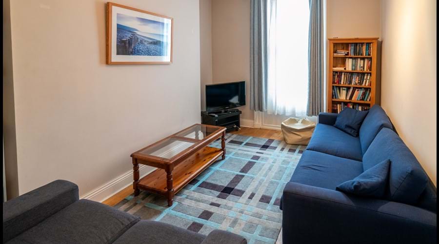 Snug sitting room with 2 sofas, TV, PS2, assorted PS2 games, small library of books, boardgames and DVDs