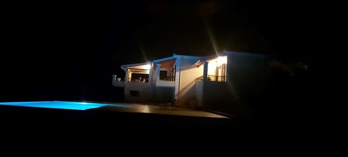 Villa and pool at night