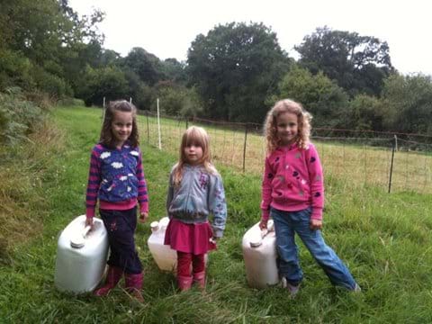 Carrying the empty water containers back from the sheep field.