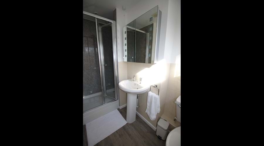 Ensuite shower room to double bedroom. Shaver point inside illuminated mirror cabinet