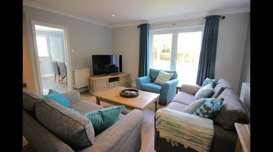 Living Room with 50" Ultra HD TV, Sky Q box with boxsets & DVD player.