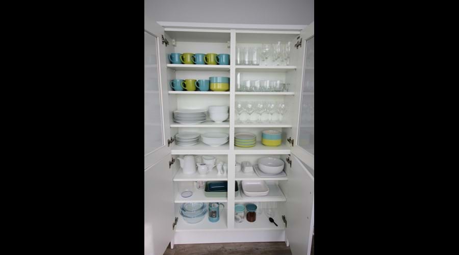 Kitchen unit with crockery and glassware